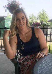 Woman with blond hair sitting at a table