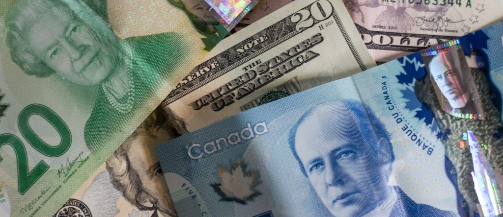 Various money from different countries in a pile together