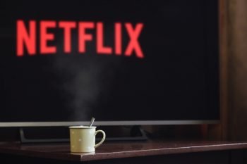 TV with mug in front and netflix logo