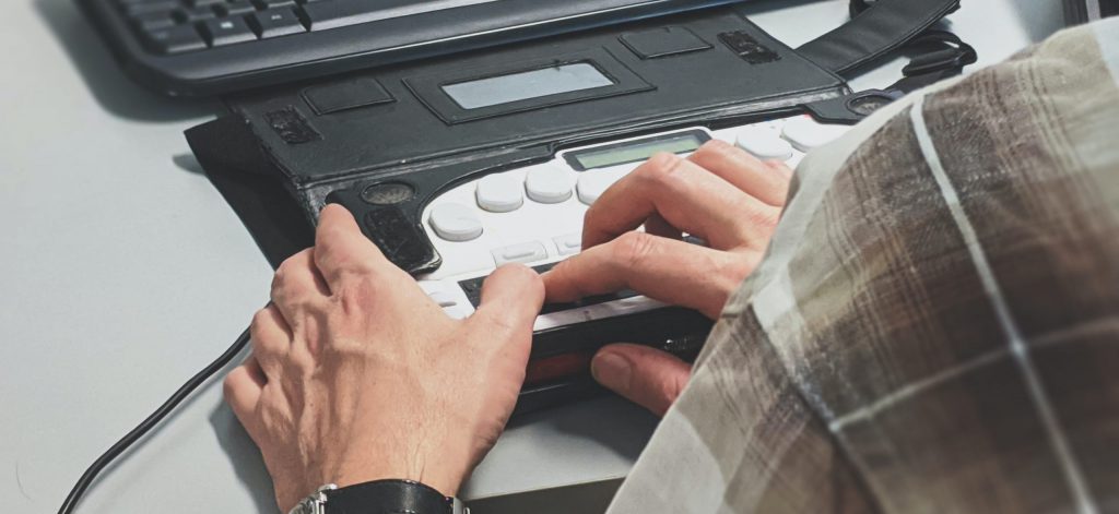 Person using an accessibility screen reader next to a keyboard