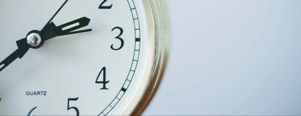 An white clock on a white background.