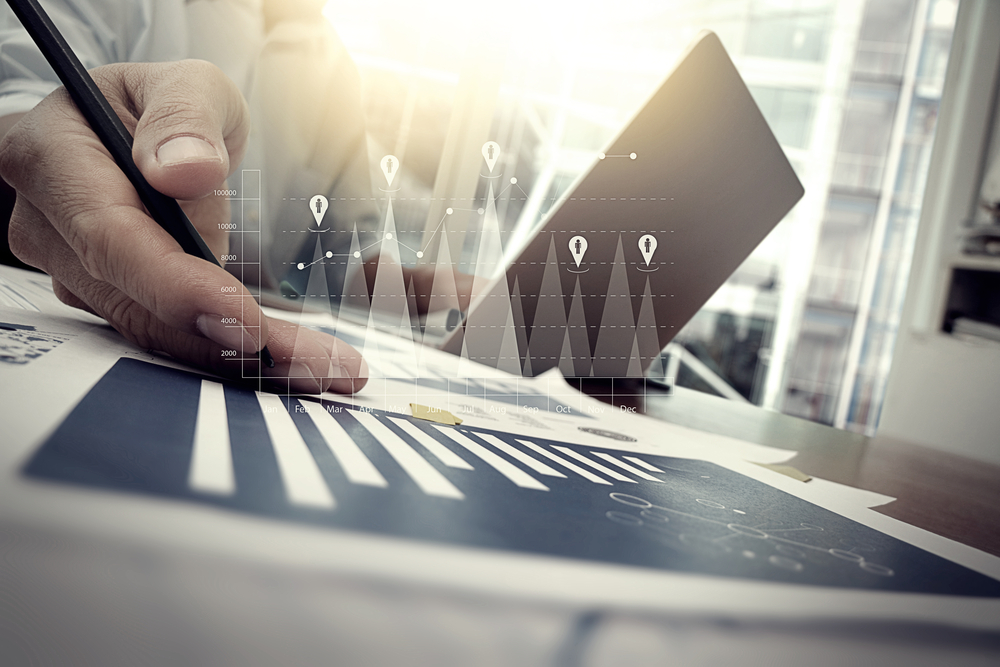 business documents on office table with smart phone and digital tablet and graph financial with social network diagram and man working in the background-2