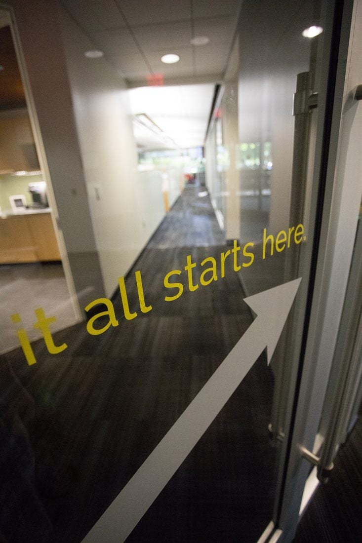Glass office door with the words it all starts here