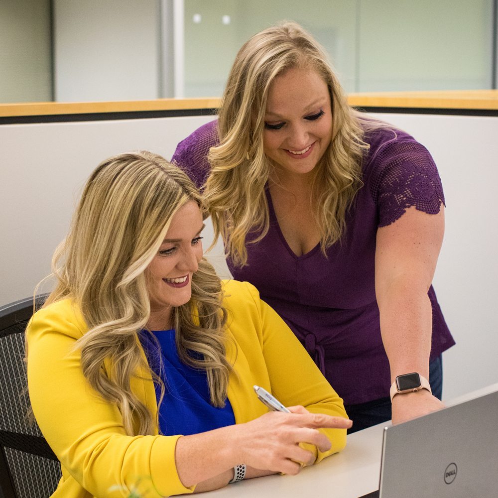 Two Issuetrak team members working at a desk