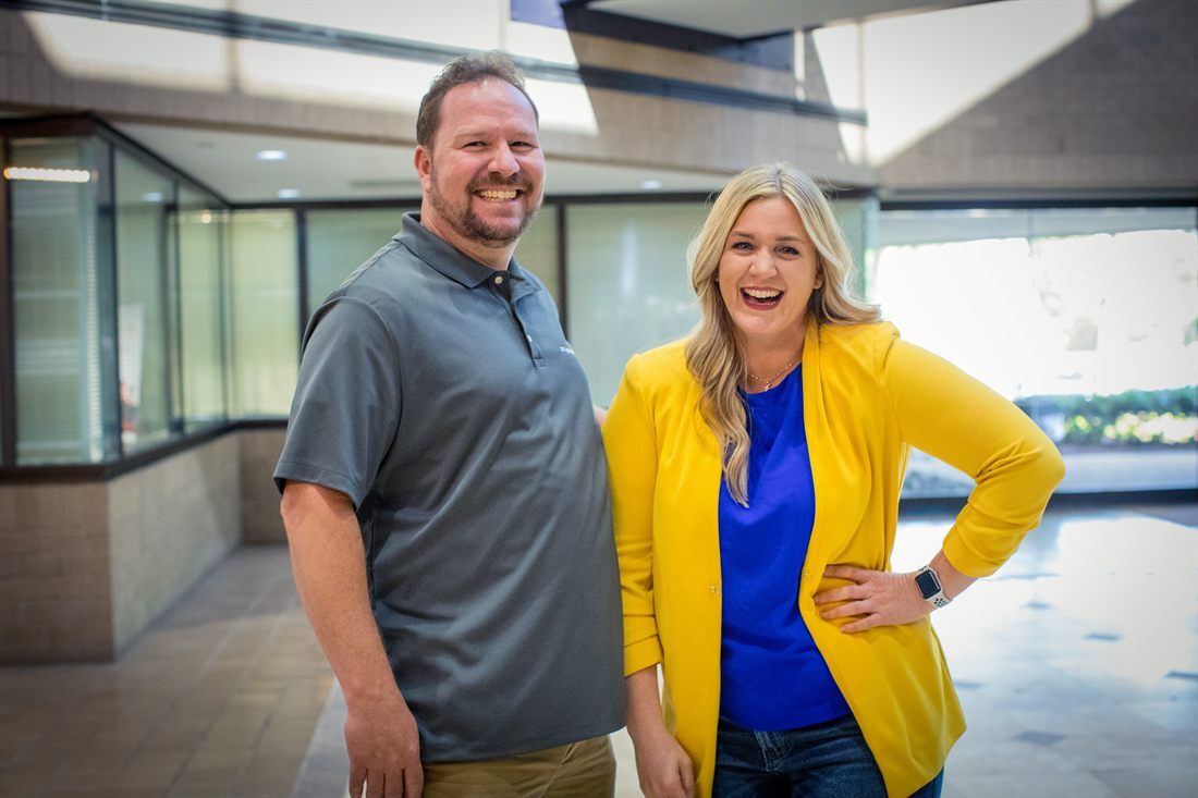 Two Issuetrak team members laughing together