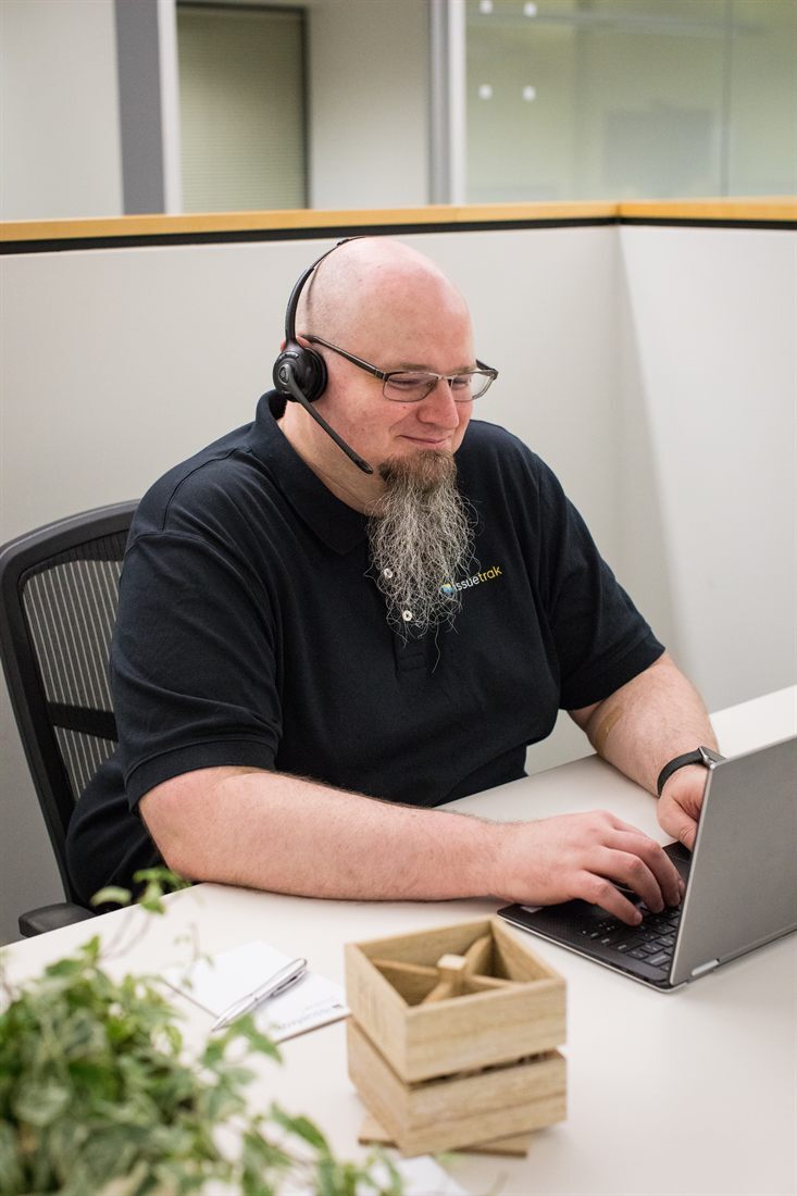 An Issuetrak support team member at work with a headset